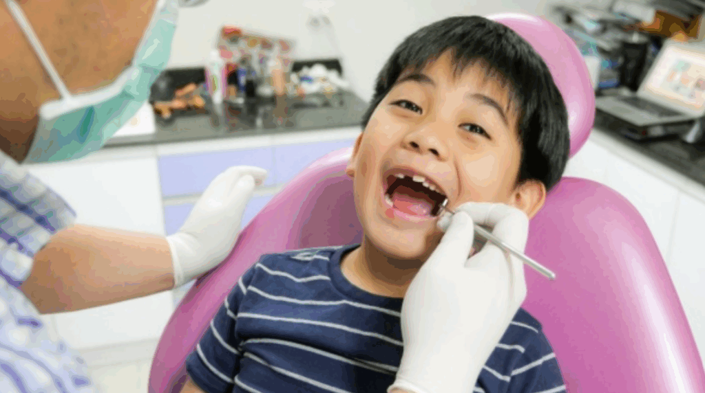 Smiling child enjoying a playful visit with a child dentist at The Dental Clinic