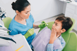 "Happy child visiting child dentist at The Dental Clinic, enjoying a fun dental experience